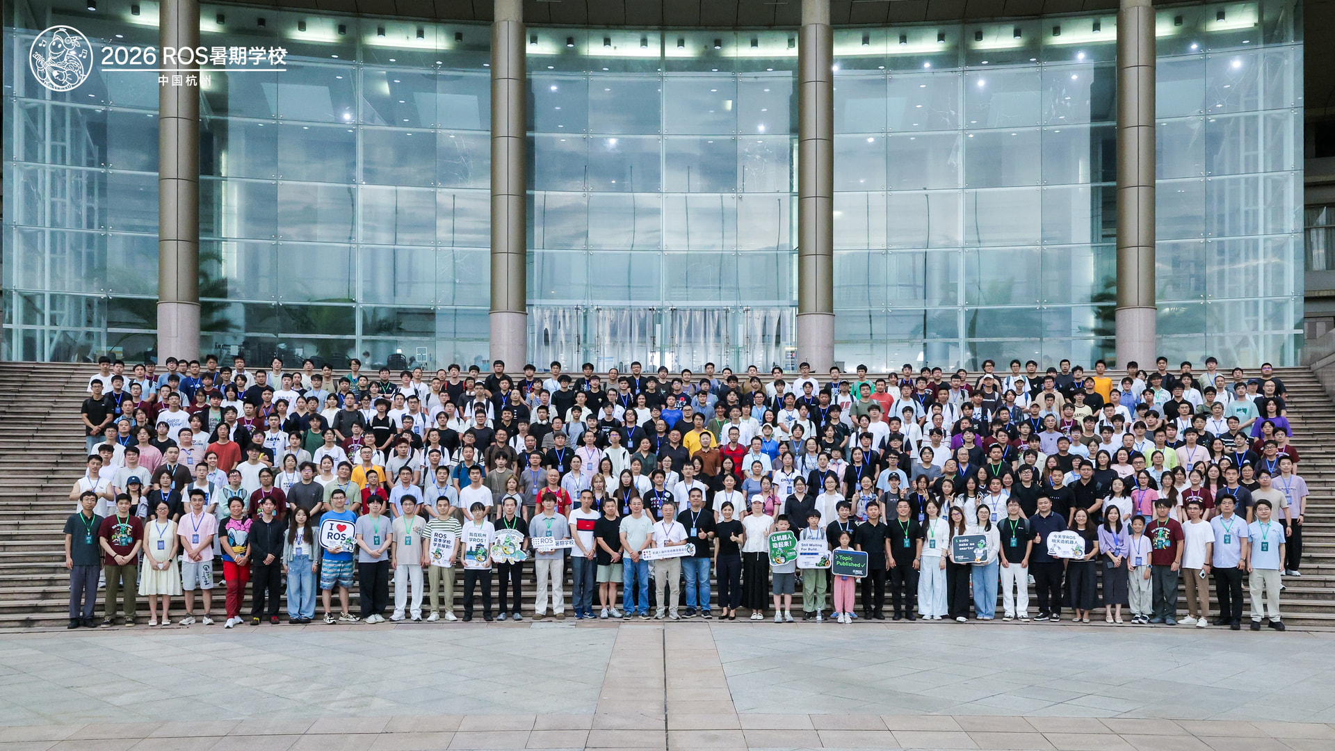 ROS Summer School participants working around a robotics training setup in Hangzhou