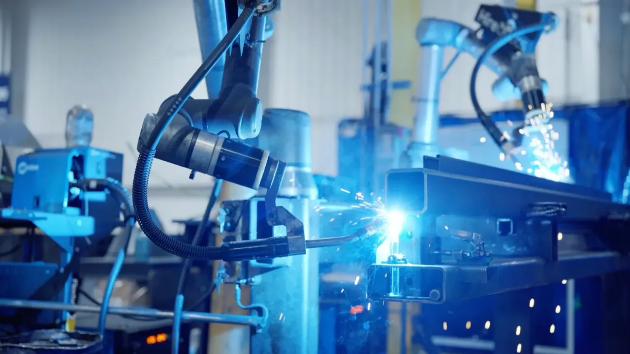 Hirebotics cobot welding a metal component in an industrial workshop