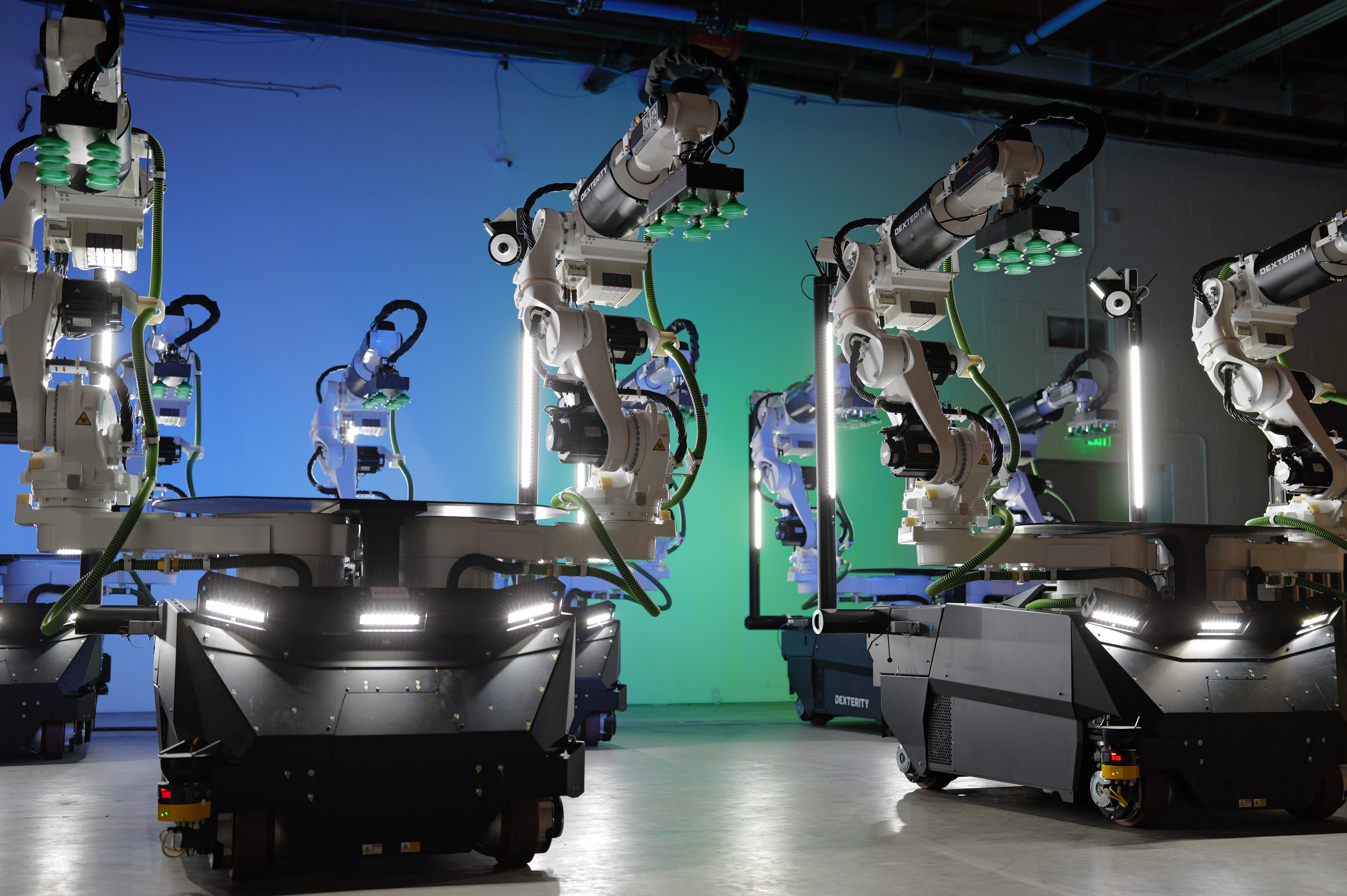 Dexterity Mech robots fitted with Kawasaki RL030N robot arms for warehouse logistics